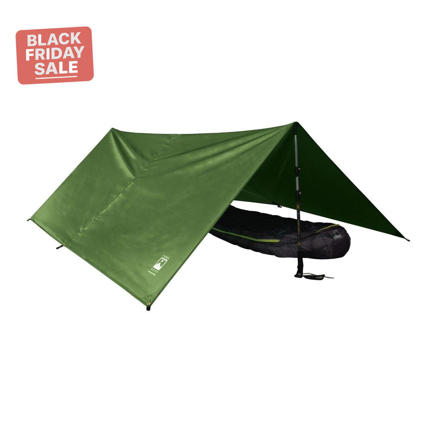 Green camping tarp with a black bag underneath on a white background.
