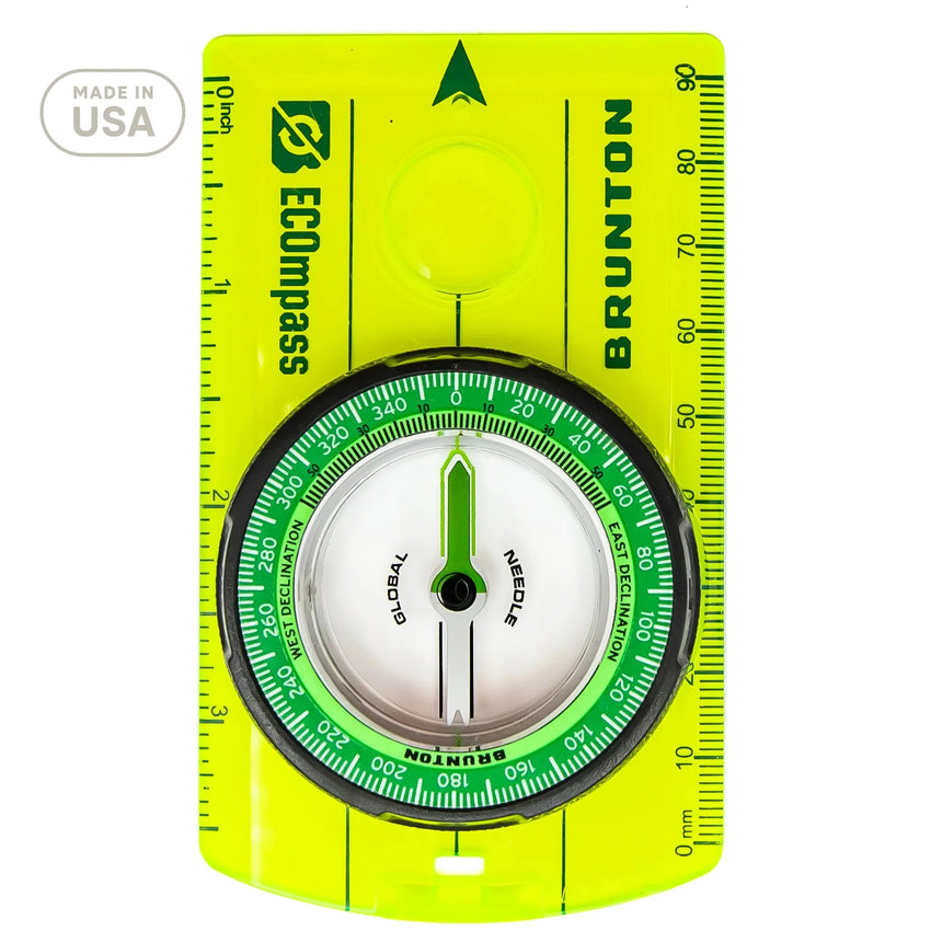 Brunton compass with green face and yellow border on a white background