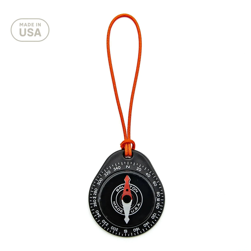 Compass with orange strap on a white background