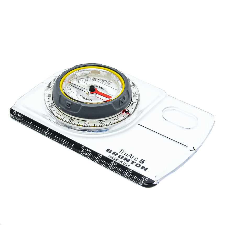 Compass with scale and clear plastic cover on a white background
