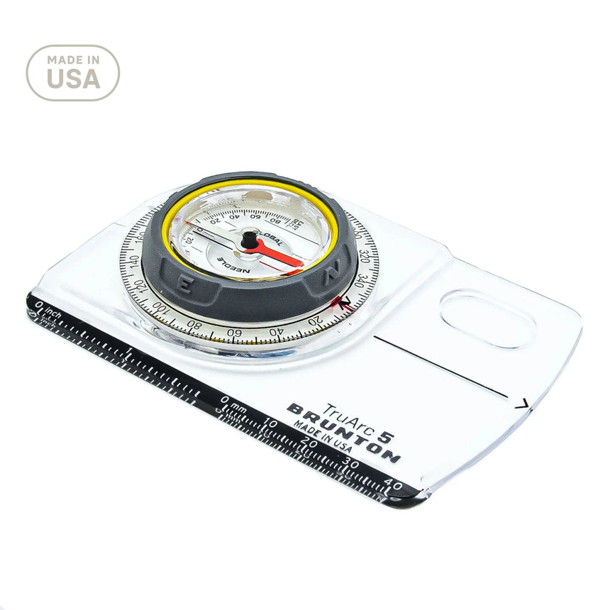 Compass with scale and clear plastic cover on a white background