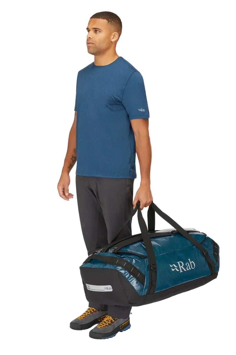 Rab Expedition II 120L Kitbag in Blue - Model Carrying as Duffel Side View