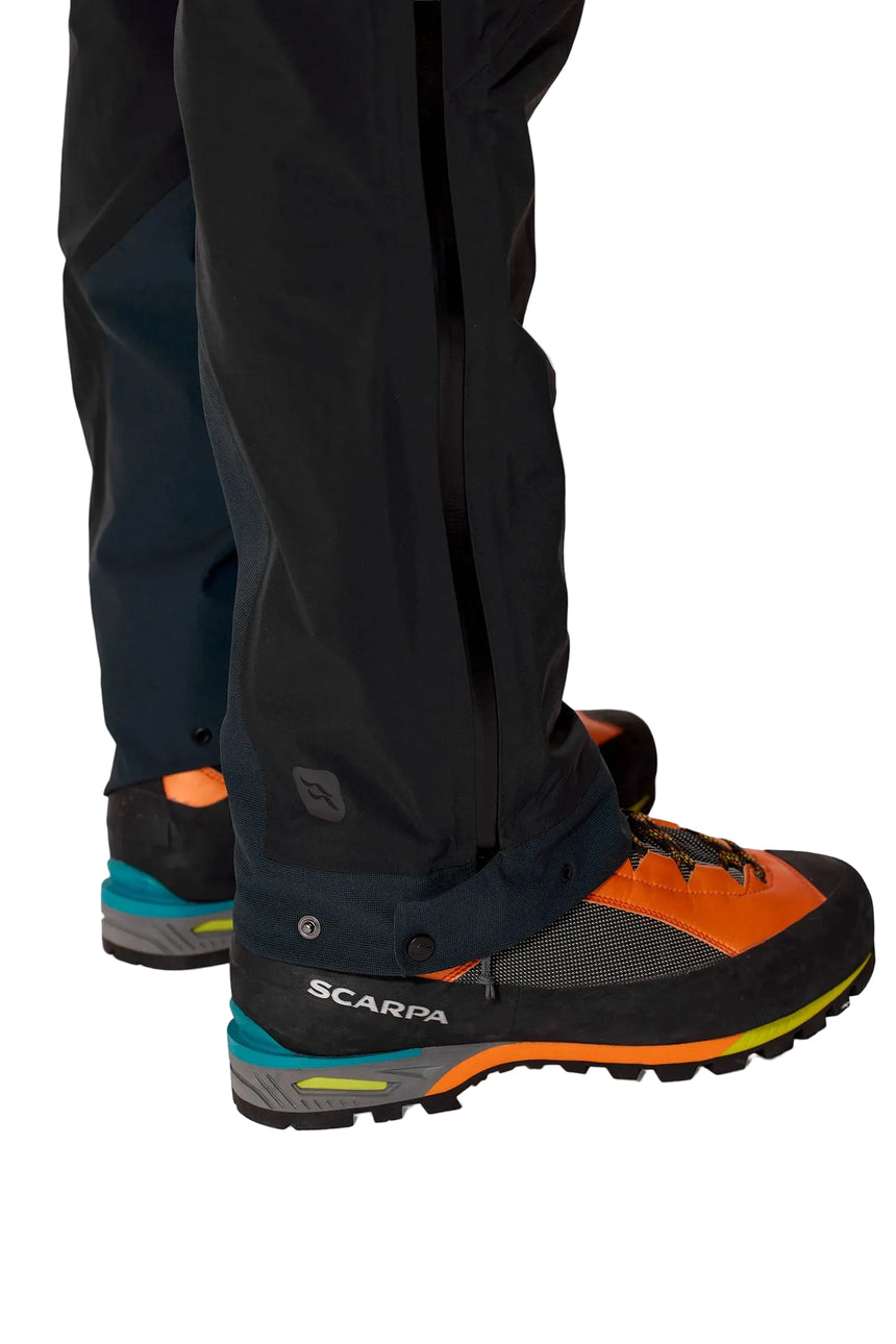 Rab Men's Firewall Guide Waterproof Pants in Black - worn side on model