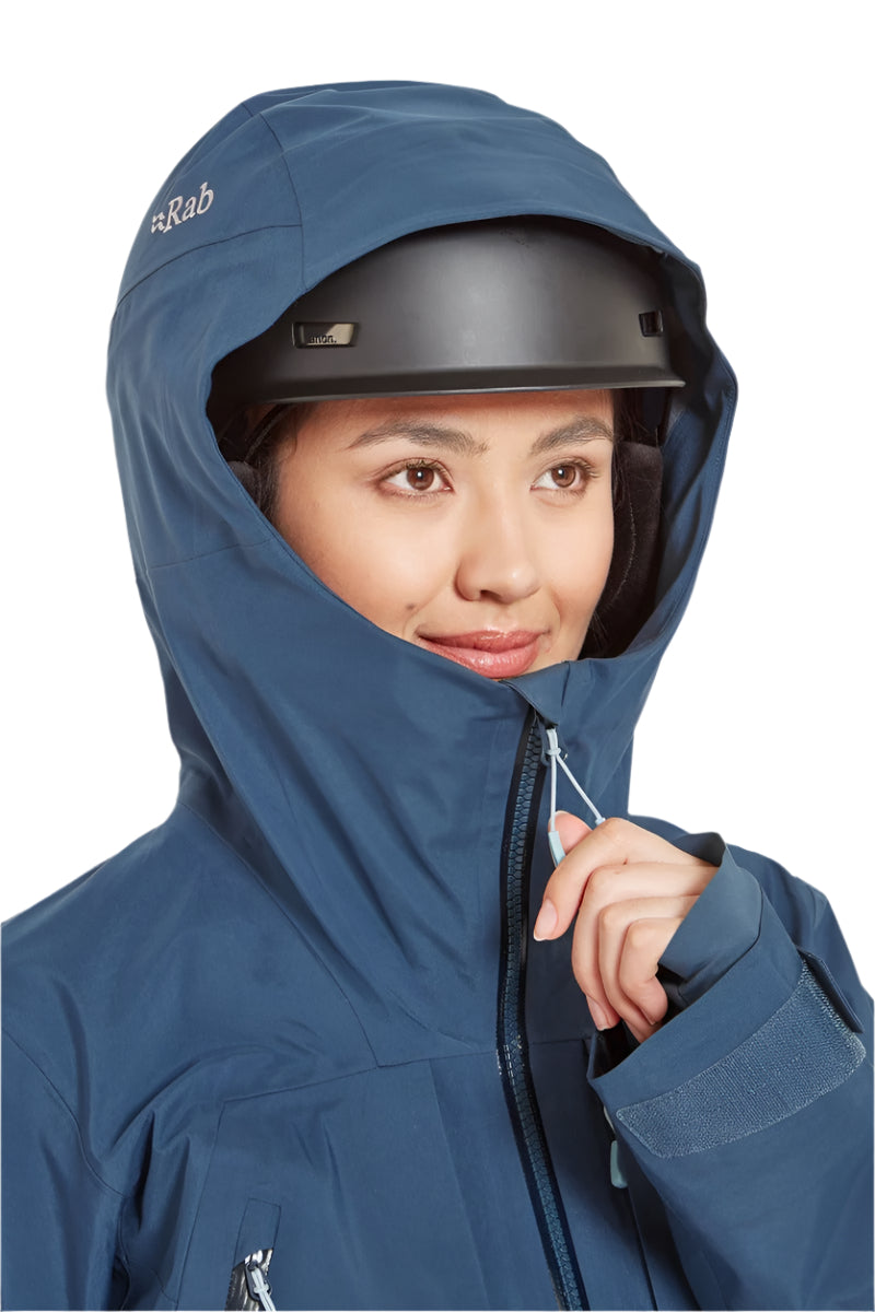Rab Women's Khroma Converge GORE-TEX Ski Jacket in Tempest Blue - worn with helmet, front (reference only, not a stocked colour)