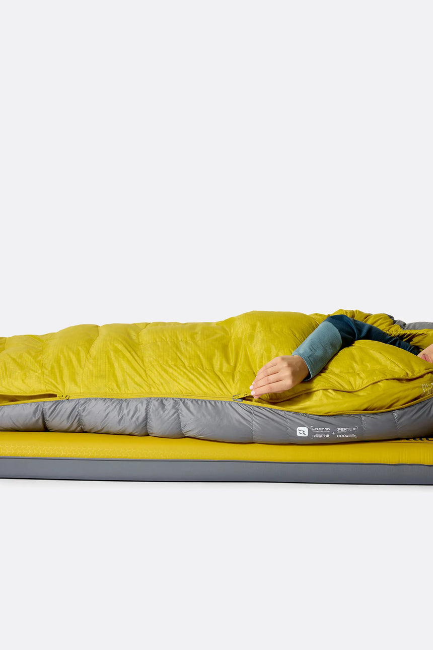 Rab Women's Neutrino Down Sleeping Bag (-6°C/20F) in Zinc/Dark Pollen - Model Lying Detail