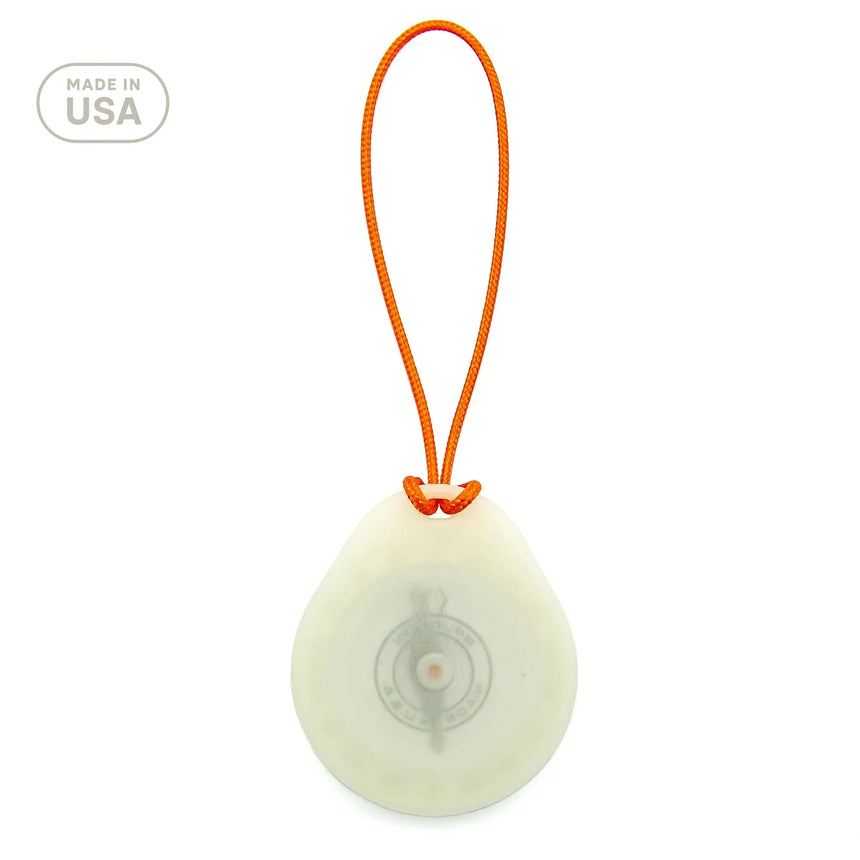 Round white device with an orange strap on a white background