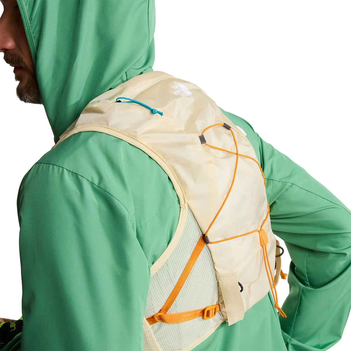 The North Face Sunriser Run Vest 8 in Desert Stone/Rust Orange - worn, front, hood up, chest detail