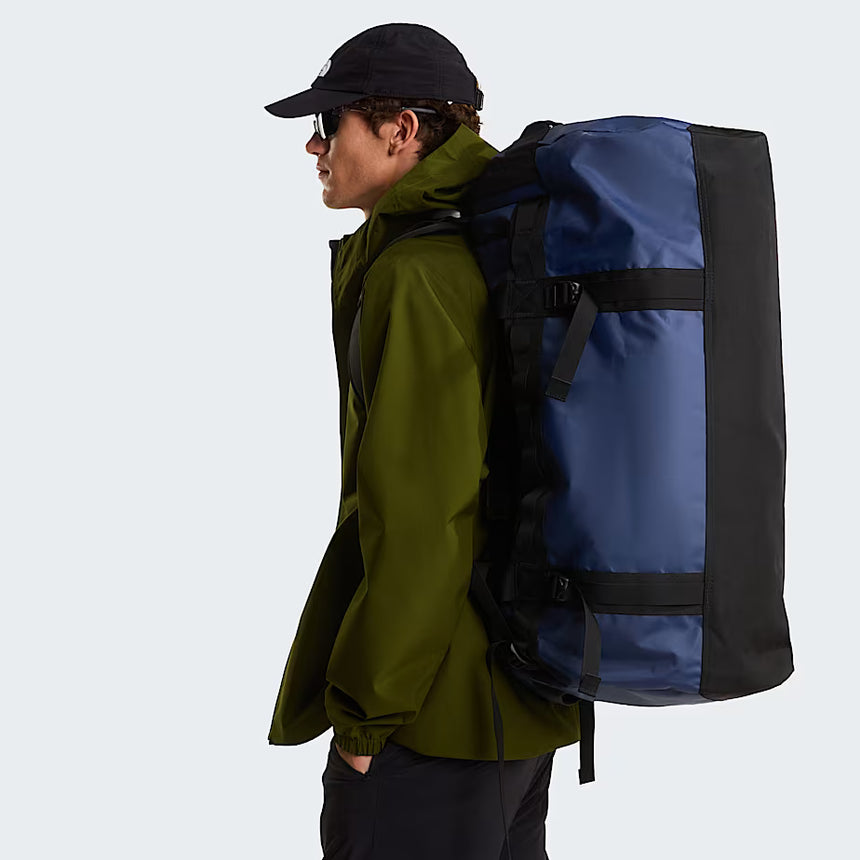 The North Face Base Camp Duffel Large Summit Navy/TNF Black - side view with detachable ergonomic shoulder straps and padded handles