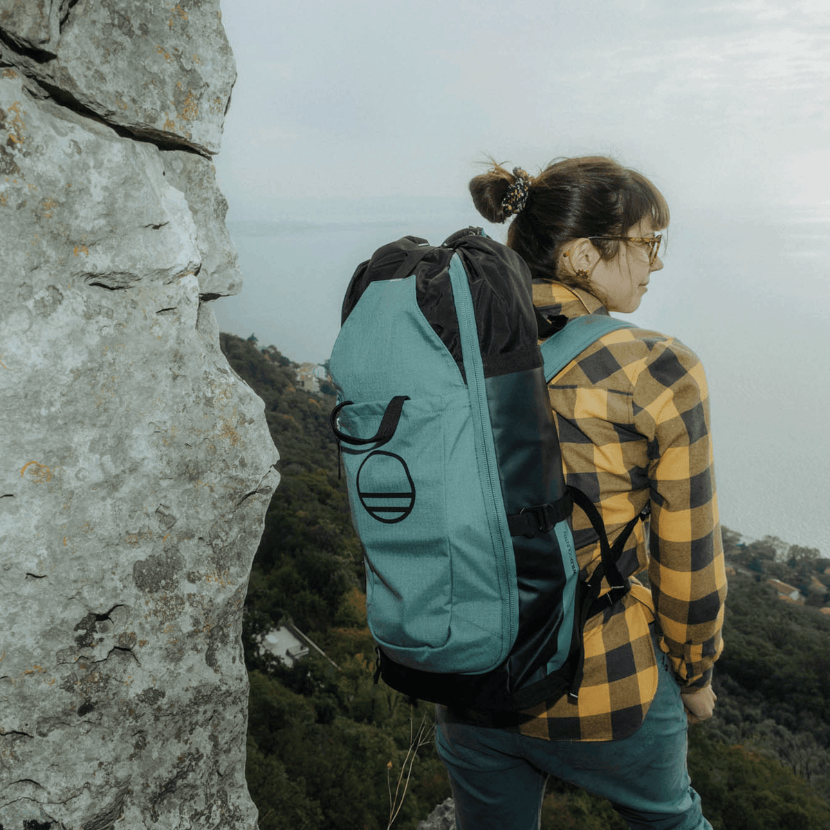 Wild Country Climbing Crag Hauler 25 Backpack Outdoor Action Black/Marsh - on models back up a mountain
