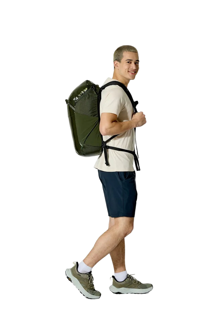 Man wearing a green backpack on a white background