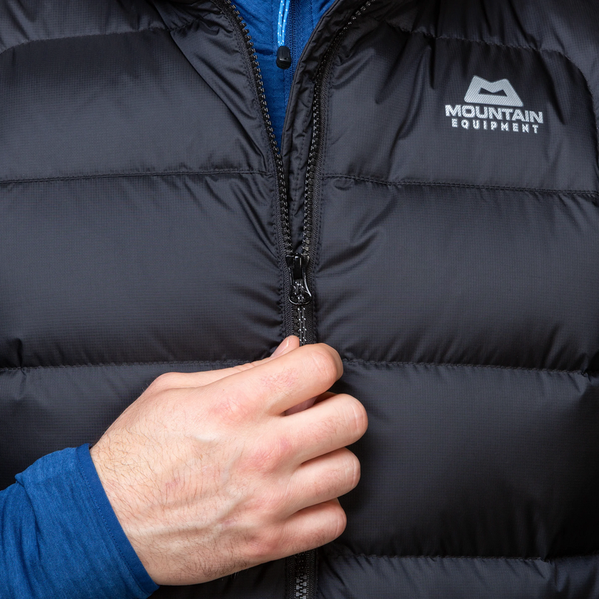 Mountain Equipment Lightline Men's Vest in Black packed into internal pocket showing lightweight packable construction