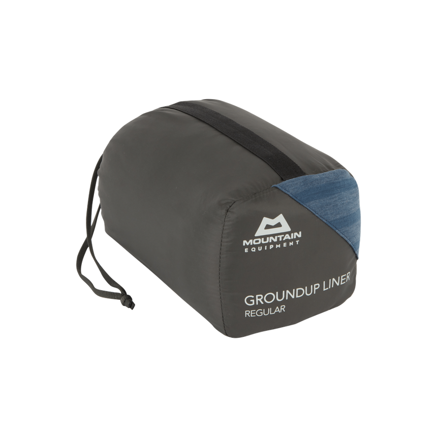 Mountain Equipment Groundup Mummy Sleeping Bag Liner in Denim Blue Stripe in stuff sack showing lightweight packable construction