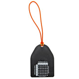 Black temperature tag with orange string on a white background