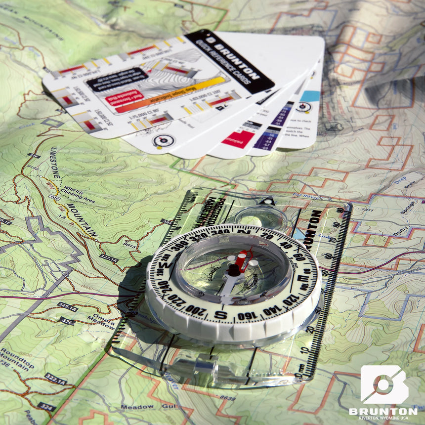 Brunton compass on a map with branded packaging