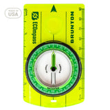 Brunton compass with green face and yellow border on a white background