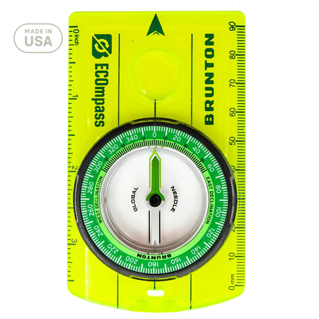 Brunton compass with green face and yellow border on a white background