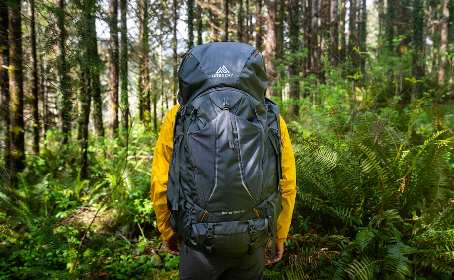 Gregory Baltoro Pro 85L Men's Backpacking Pack in Iron Grey - On Trail in Forest