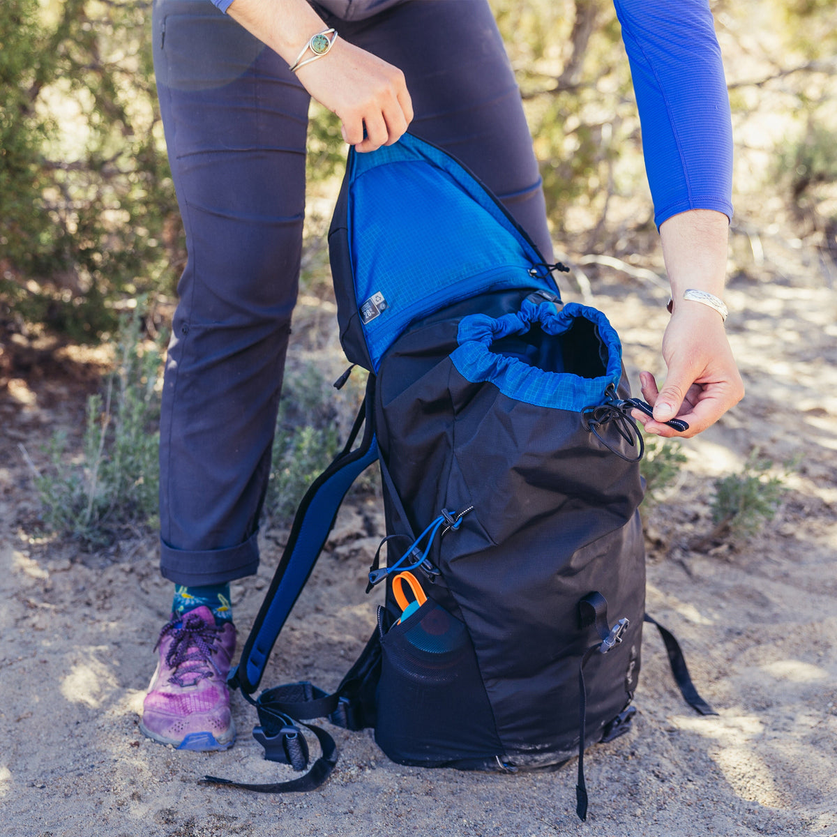 Gregory Kiro 28L Daypack in Alpine Black - top lid drawcord detail, worn