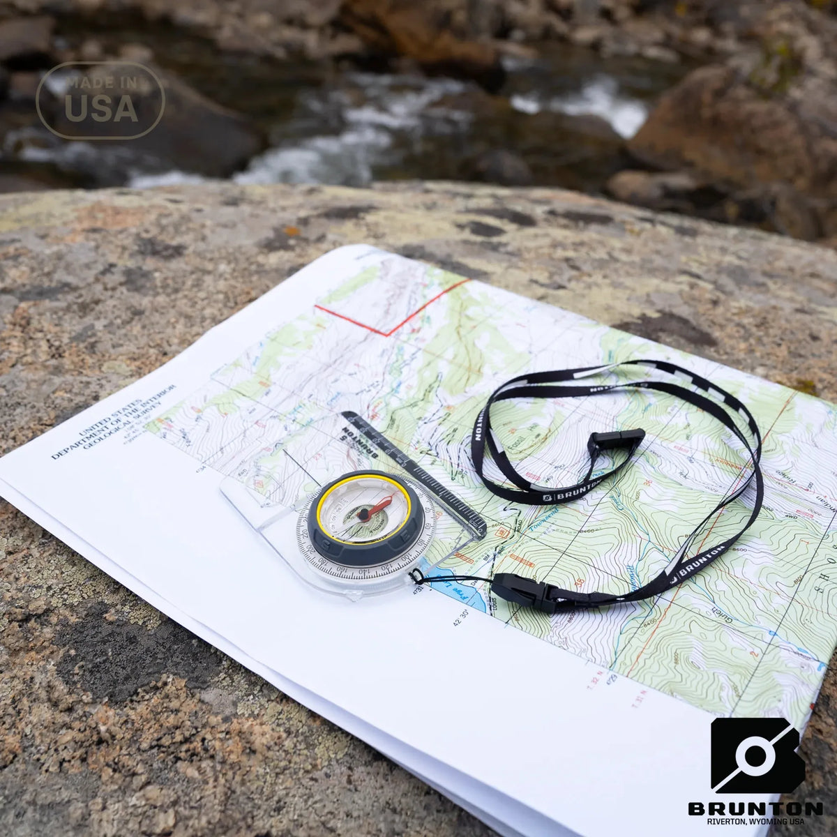 Map with compass and Brunton logo on a rock