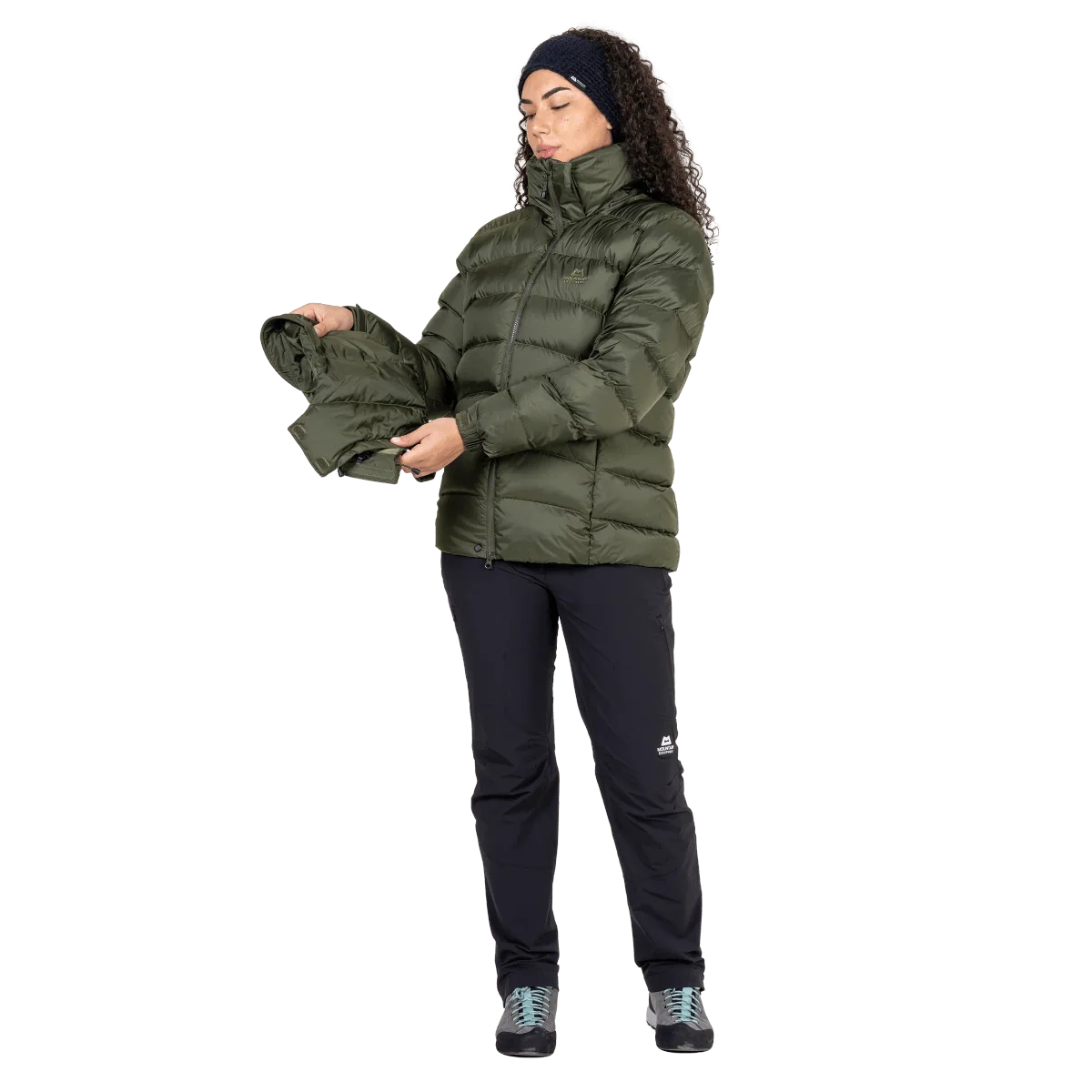 Mountain Equipment Lightline Women's Jacket in Buckthorn packed into stuff sack on model showing lightweight packable construction