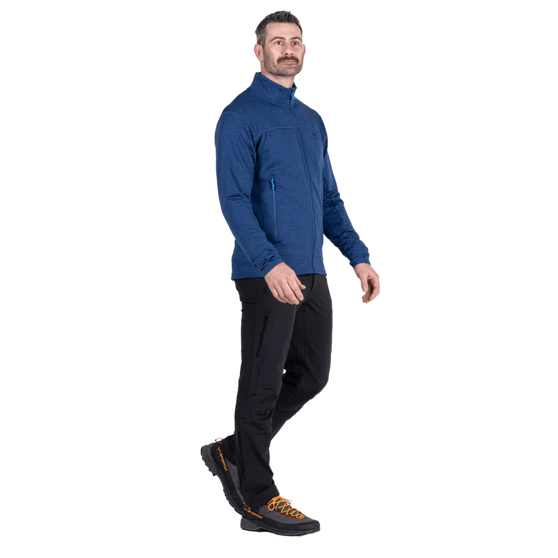 A man modeling a blue quarter-zip fleece jacket, black pants, and hiking boots against a plain white background.Outdoor Action