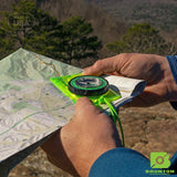 Person using a compass on a map outdoors with Brunton logo.