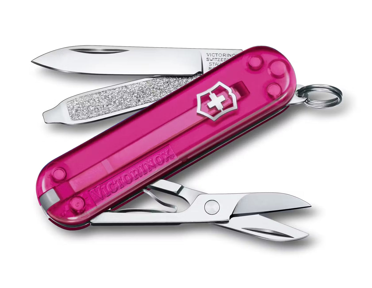 Pink Victorinox Swiss Army knife open on a white background