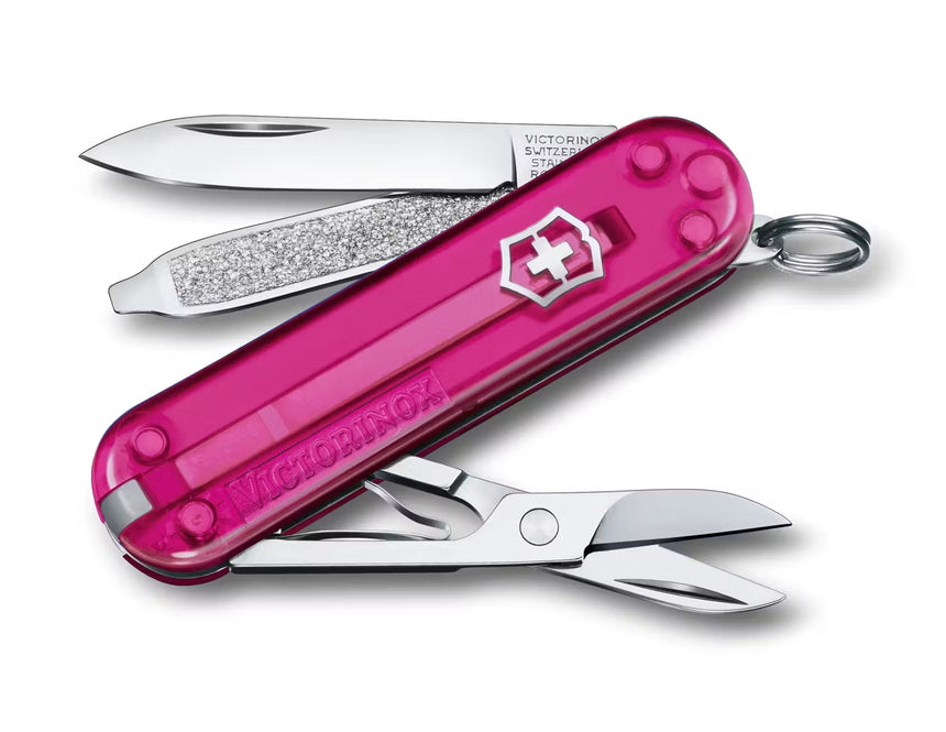 Pink Victorinox Swiss Army knife open on a white background