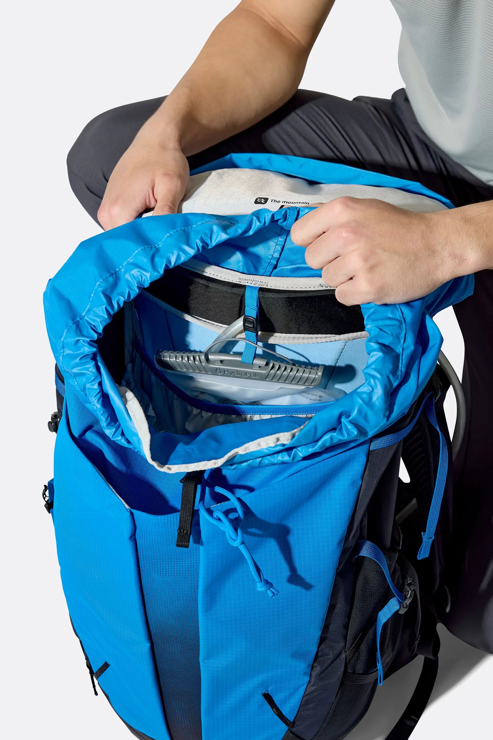 Rab Airox 30 Day Pack in Maya Blue/Black - Three Quarter View On Model 2