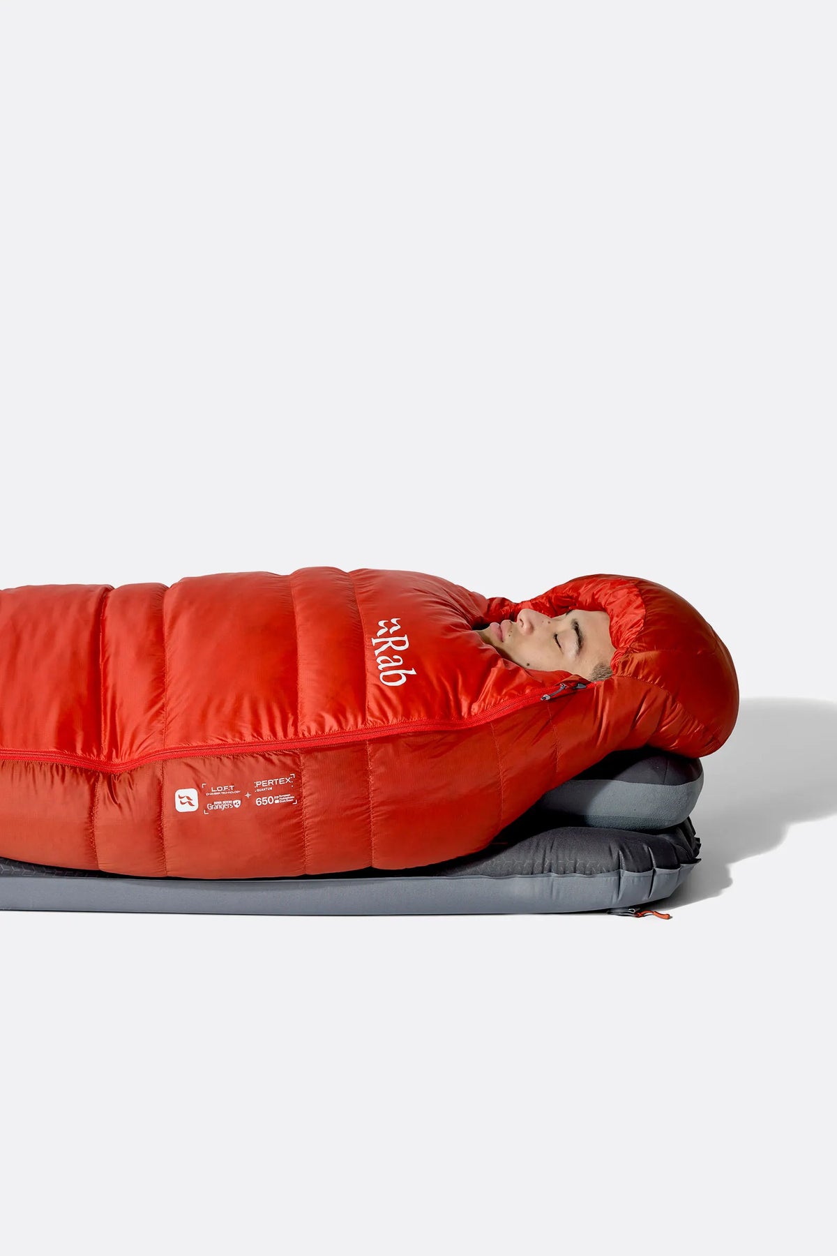 Rab Alpine Down Sleeping Bag (0°C/32F) in Dark Horizon/Tuscan Red - worn, side sleeping