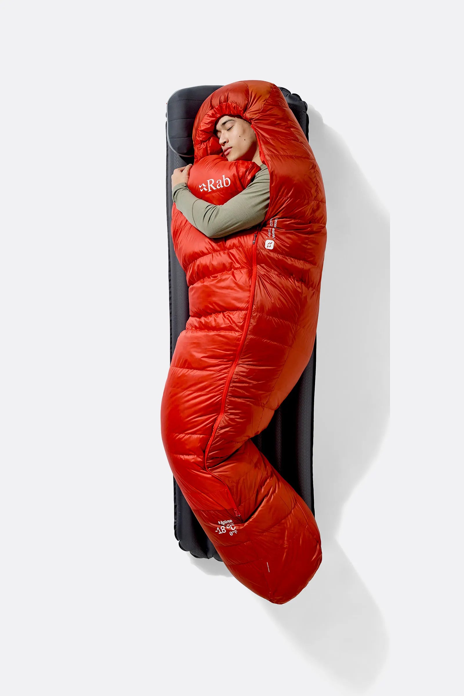 Rab Alpine Down Sleeping Bag (0°C/32F) in Dark Horizon/Tuscan Red - worn, side sleeping