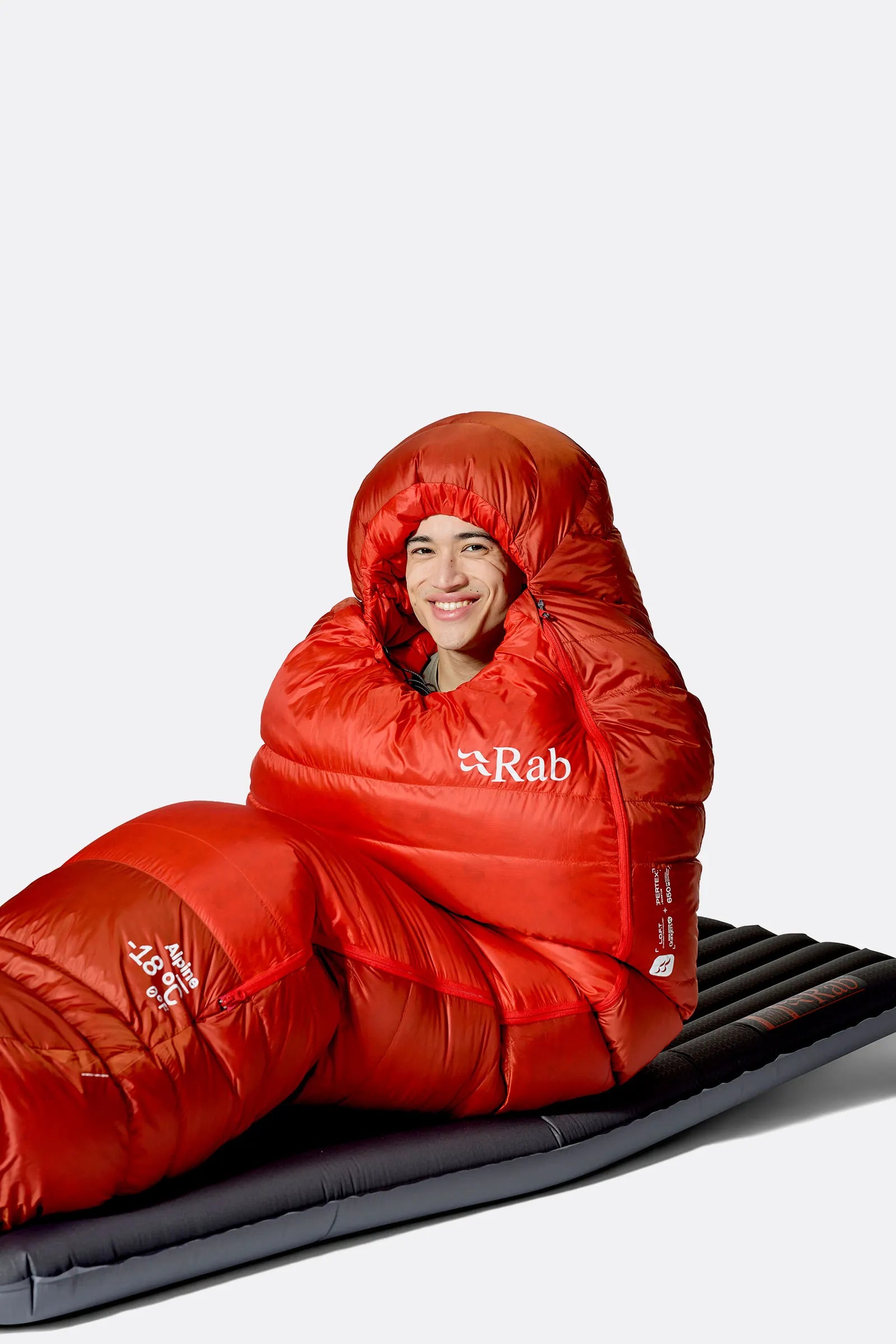 Rab Alpine Down Sleeping Bag (-12°C/10F) in Dark Horizon/Tuscan Red - worn, sitting up