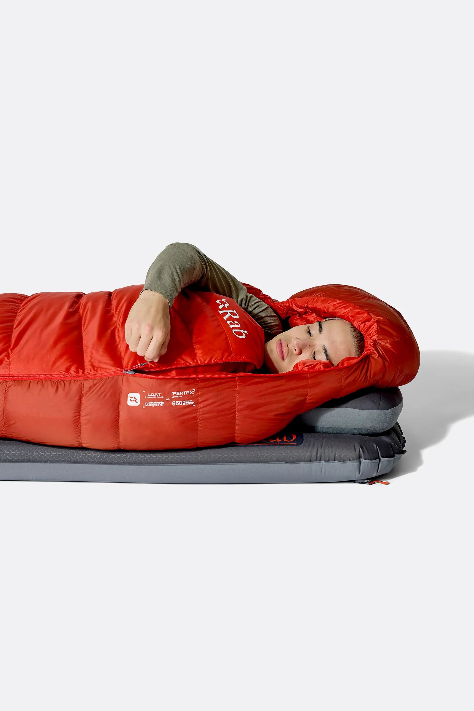 Rab Alpine Down Sleeping Bag (-18°C/0F) in Dark Horizon/Tuscan Red - Model Lying Wrapped on Mat