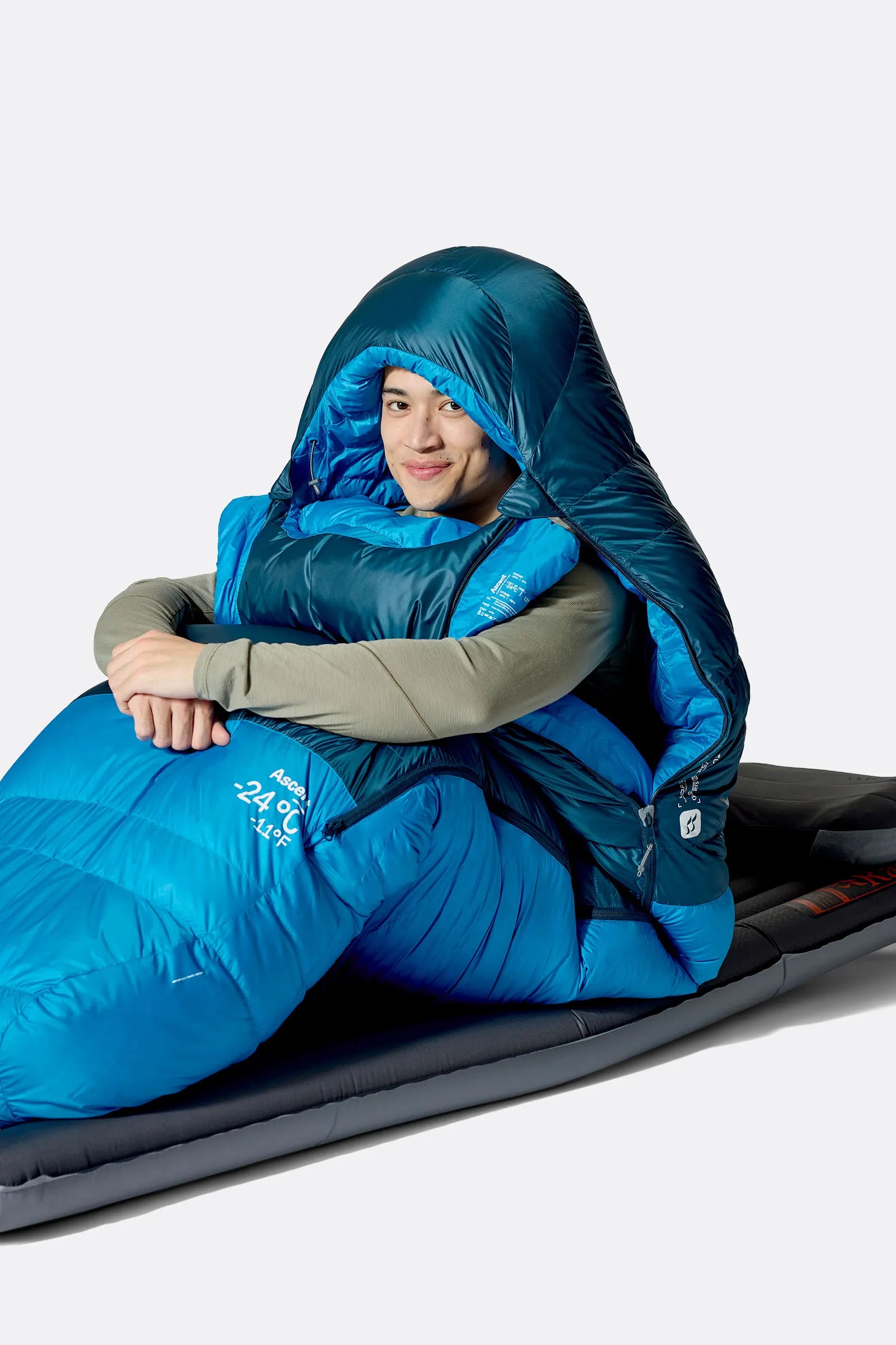 Rab Ascent Down Sleeping Bag (0°C/32F) in Tempest Blue/Maya Blue - Model Seated Hood