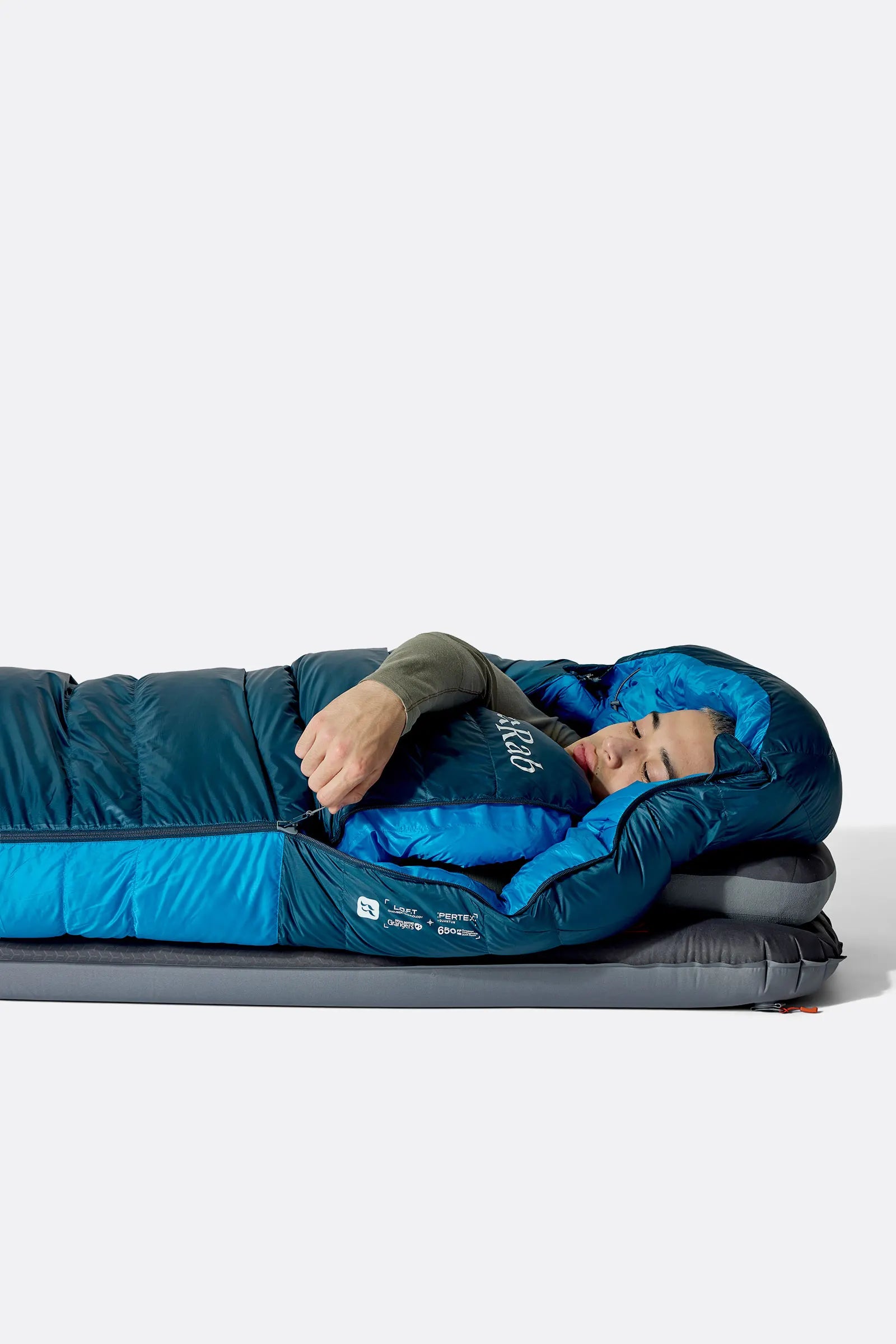 Rab Ascent Down Sleeping Bag (-6°C/21F) in Tempest Blue/Maya Blue - Model Lying Wrapped