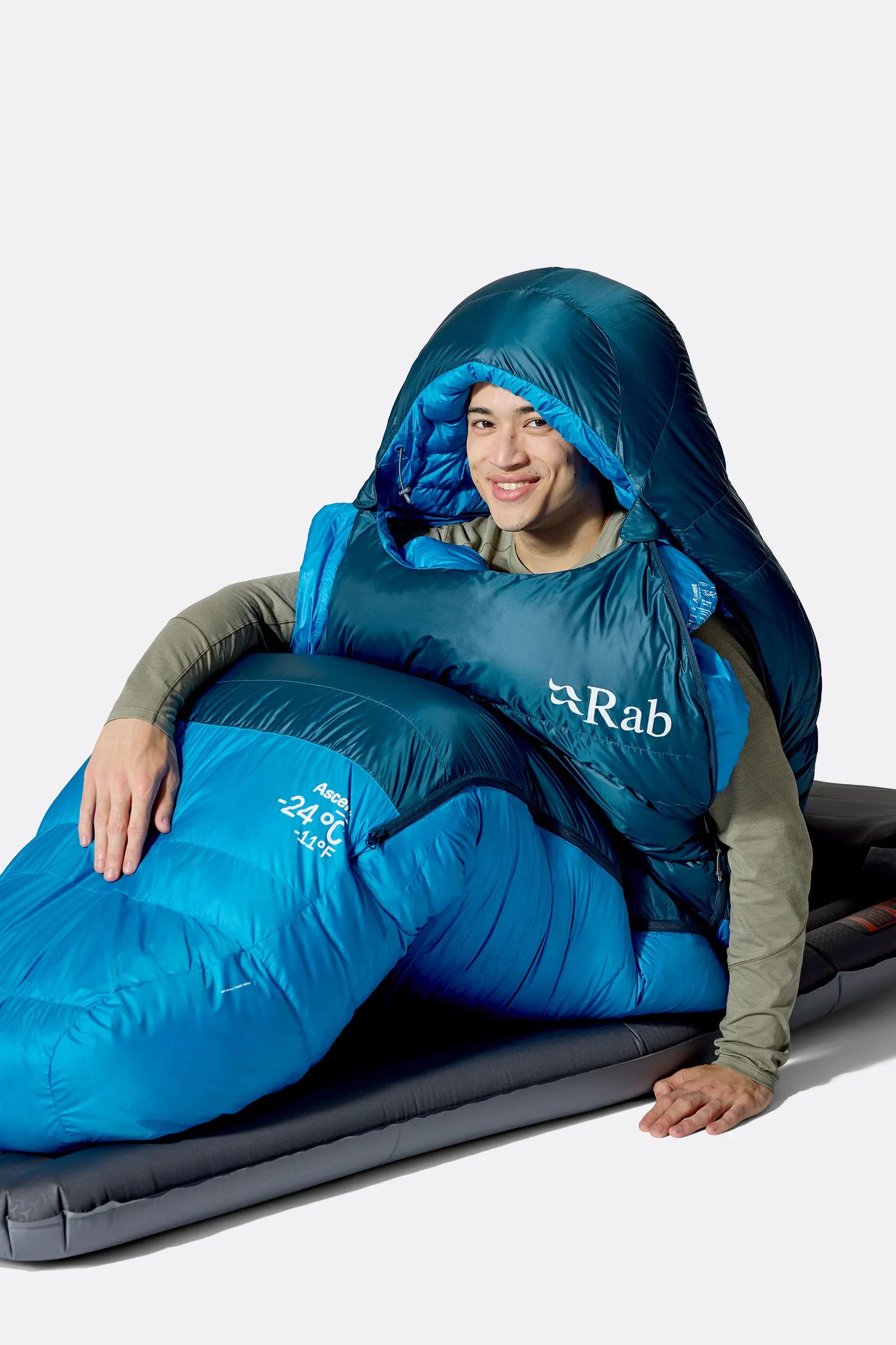 Rab Ascent Down Sleeping Bag (-6°C/21F) in Tempest Blue/Maya Blue - Model Seated