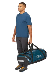 Rab Expedition II 120L Kitbag in Blue - Model Carrying as Duffel Side View