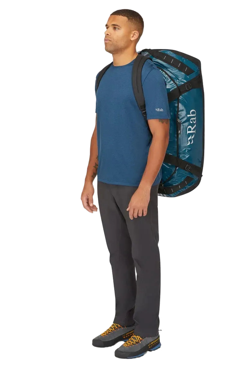 Rab Expedition II 120L Kitbag in Blue - Model Carrying Over Shoulder