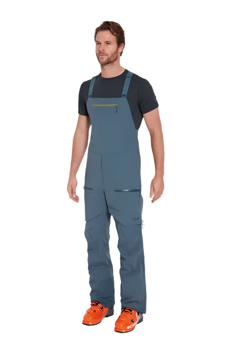 Rab Men's Khroma Kinetic Waterproof Bib Pants in Orion Blue - worn, three-quarter