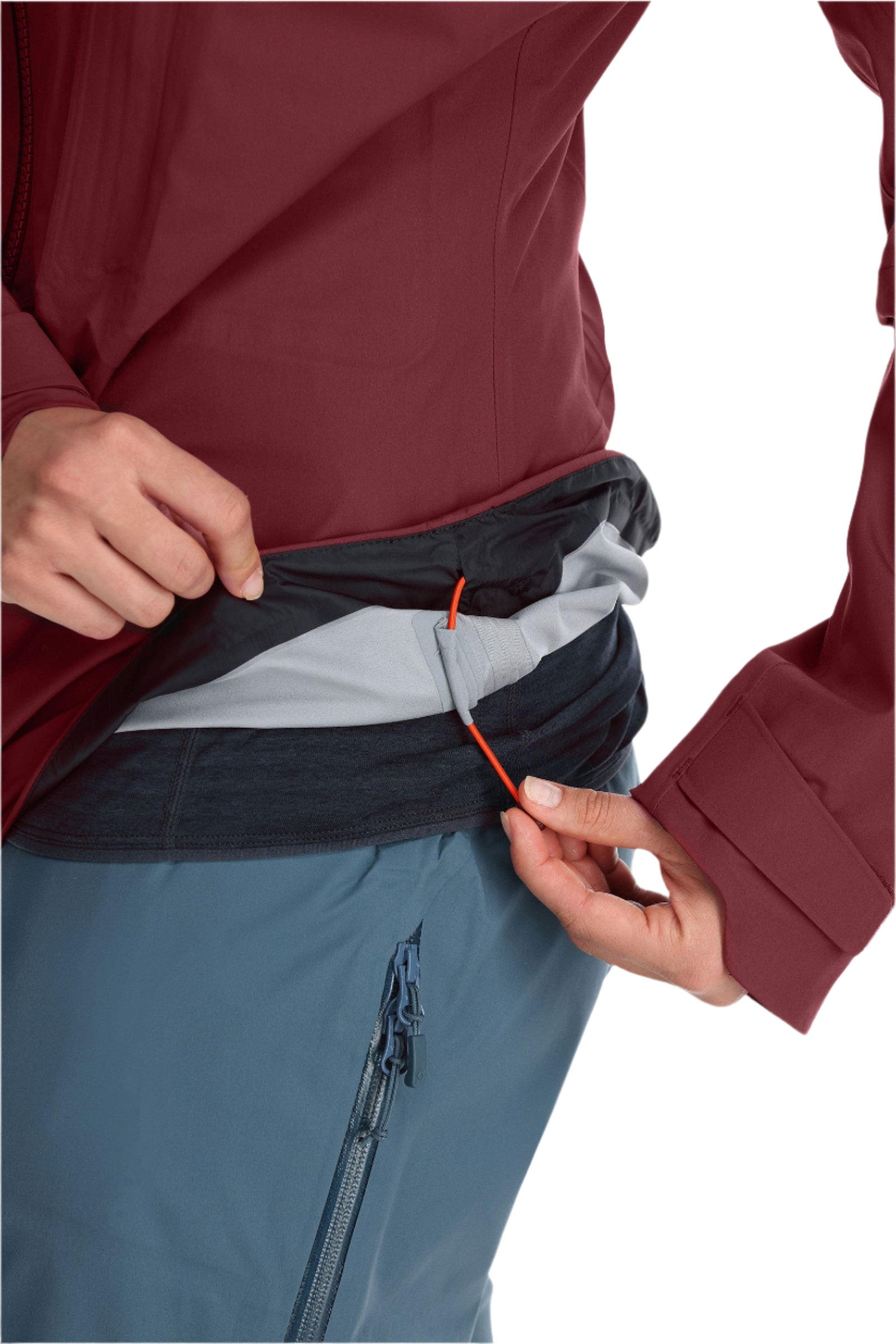 Rab Women's Khroma Kinetic Waterproof Ski Jacket in Deep Heather - hem adjustment detail, worn