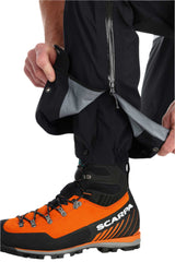 Rab Men's Latok GORE-TEX Pro Bib Pants in Black - hem gaiter detail, worn