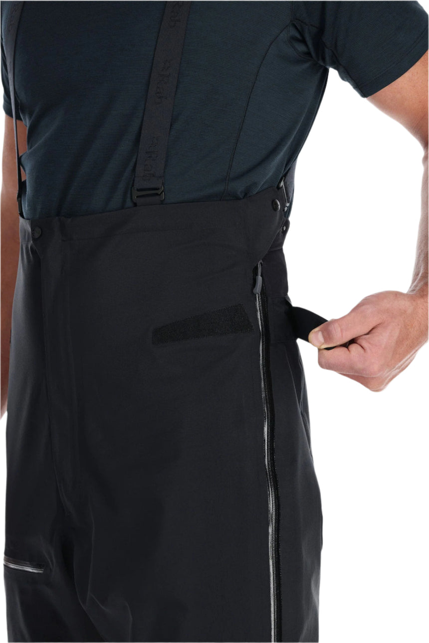 Rab Men's Latok GORE-TEX Pro Bib Pants in Black - side zip detail, worn