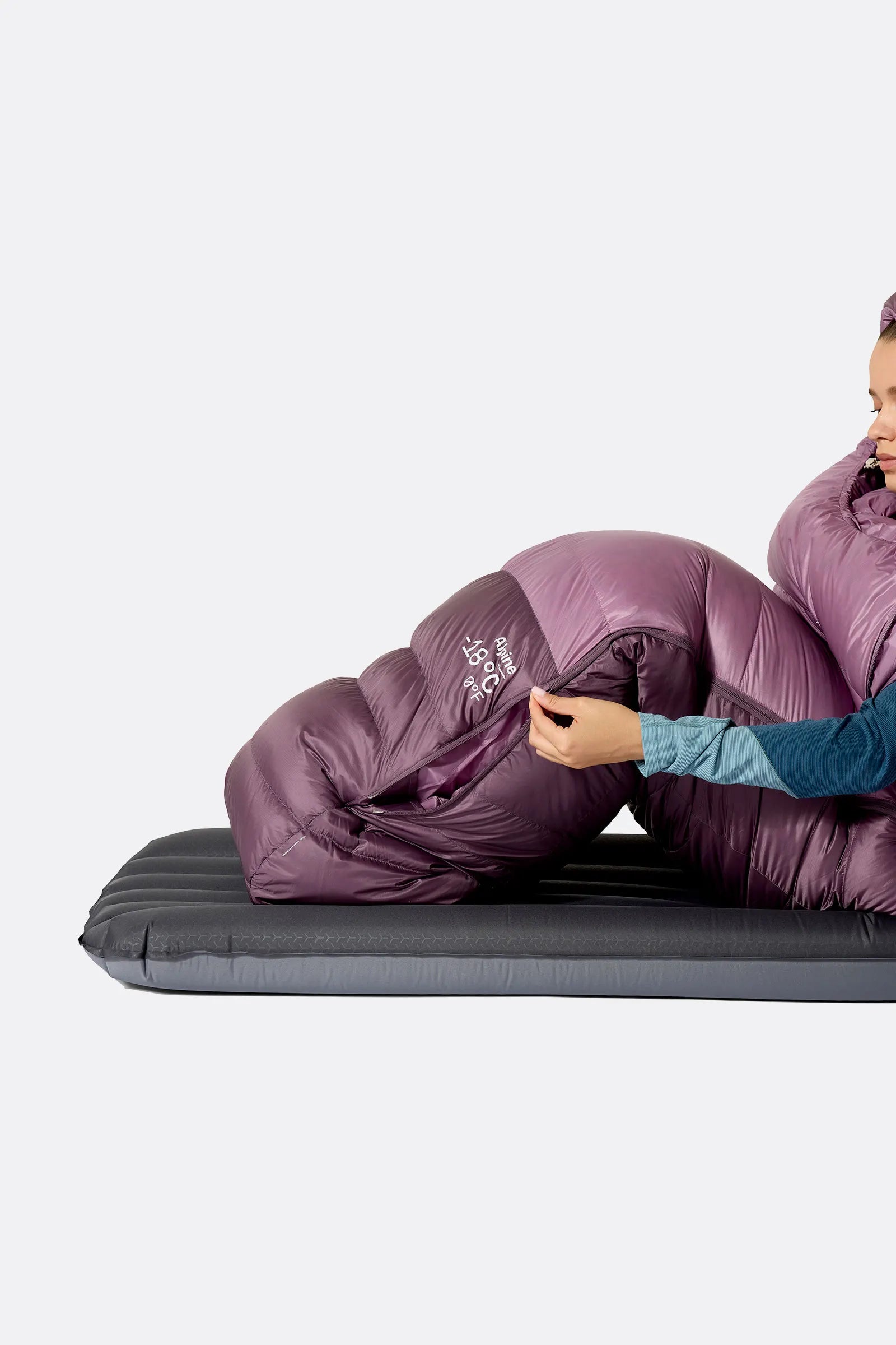 Rab Women's Alpine Down Sleeping Bag (-12°C/10F) in Iris/Dark Iris - Model Lying Side