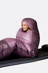 Rab Women's Alpine Down Sleeping Bag (-12°C/10F) in Iris/Dark Iris - Model Seated Hood