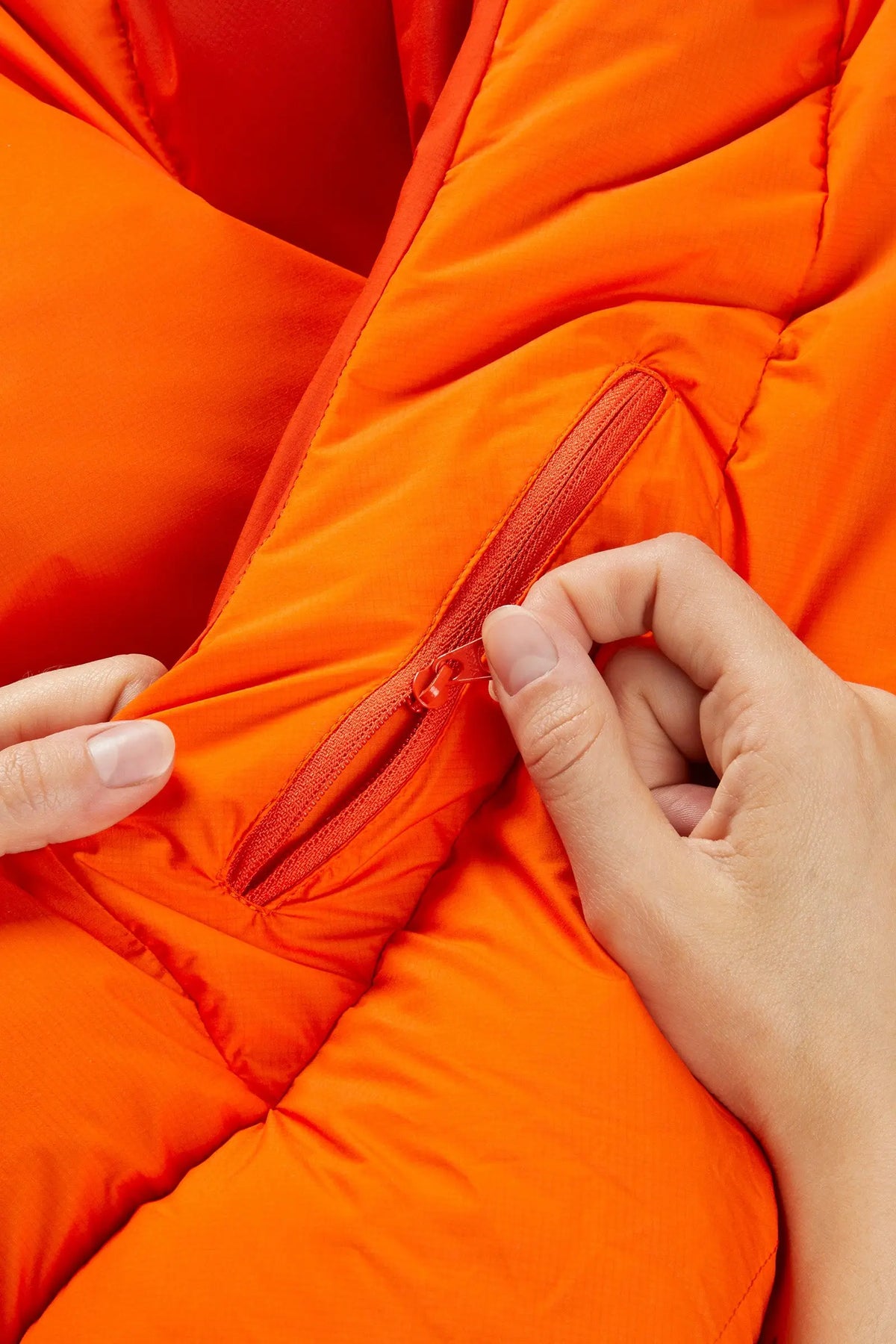 Rab Women's Andes Infinium 800 Down Sleeping Bag in Atomic - zip pull detail, worn