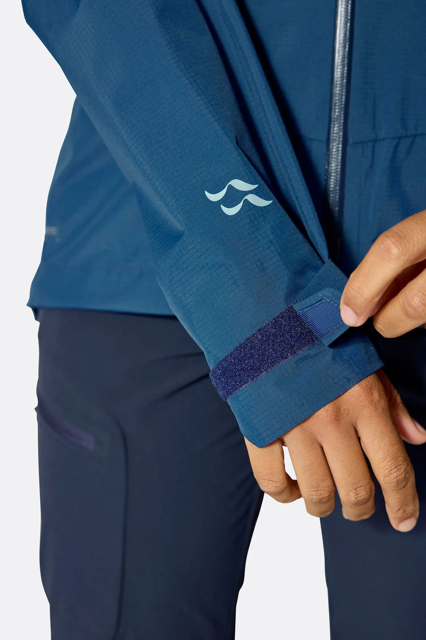 Rab Women's Downpour Mountain Waterproof Jacket in Tempest Blue - sleeve logo detail, side