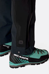 Rab Women's Firewall Guide Waterproof Pants in Black - hem and crampon patch detail on model