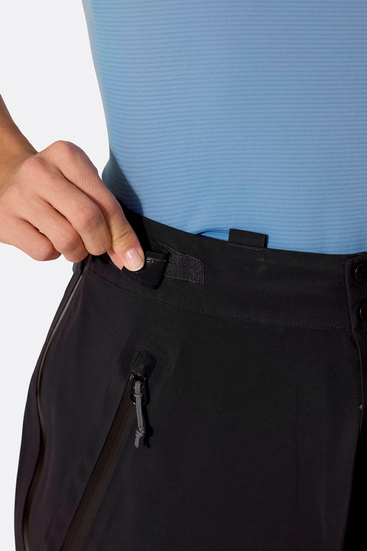 Rab Women's Firewall Guide Waterproof Pants in Black - hook-and-loop waist strap detail on model