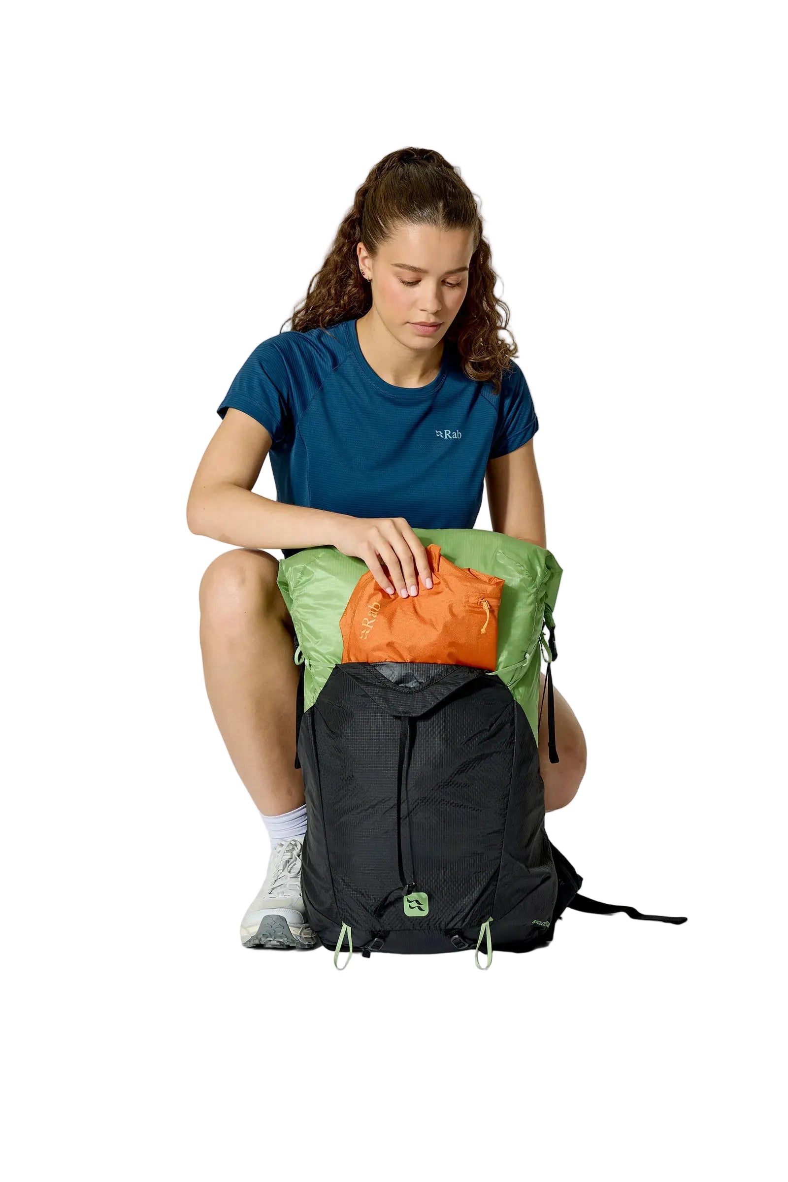 Rab Women's Syclon XP ND 38L Waterproof Pack in Black/Dark Fig Green - Seated View On Model