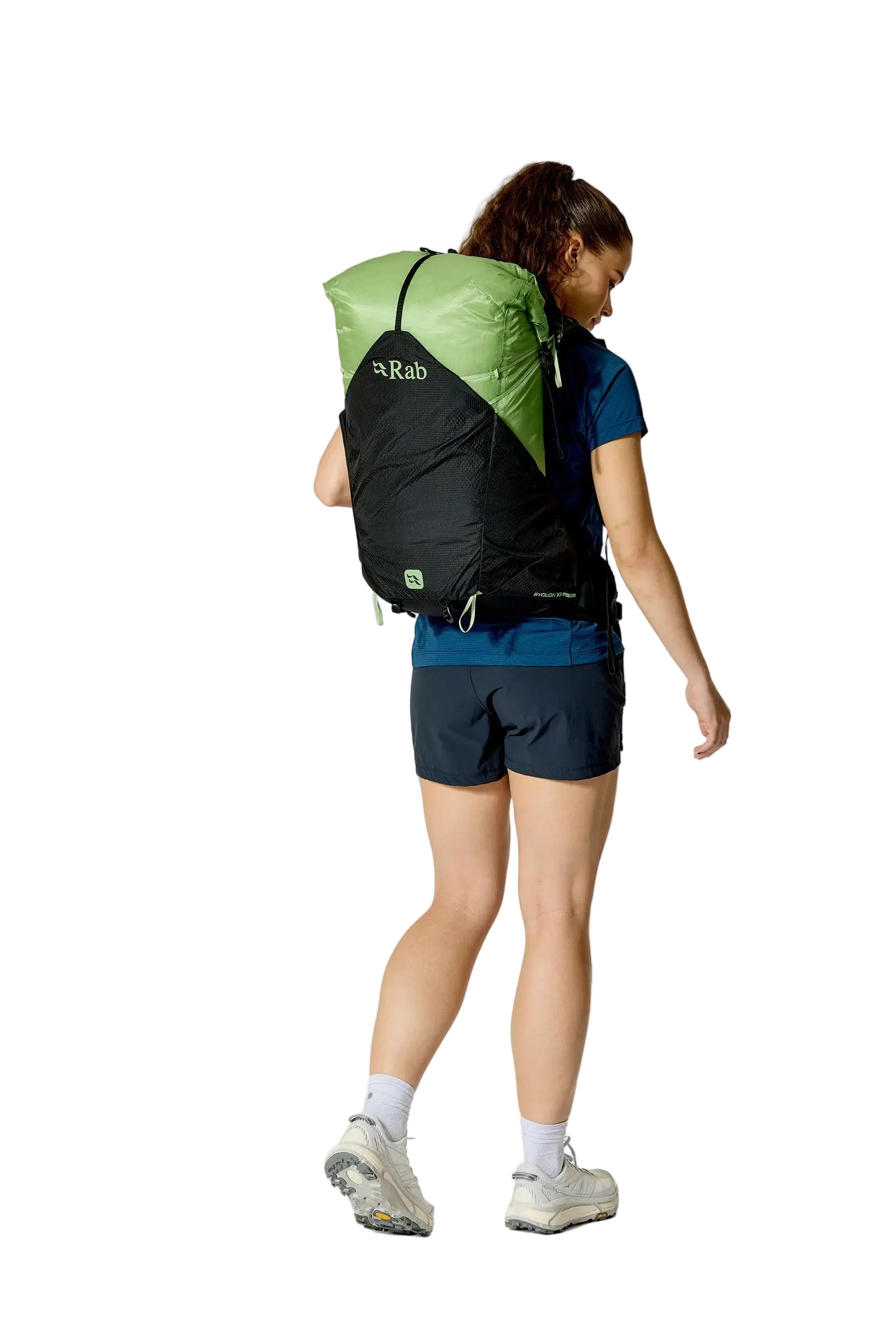 Rab Women's Syclon XP ND 38L Waterproof Pack in Black/Dark Fig Green - Three Quarter View On Model 2